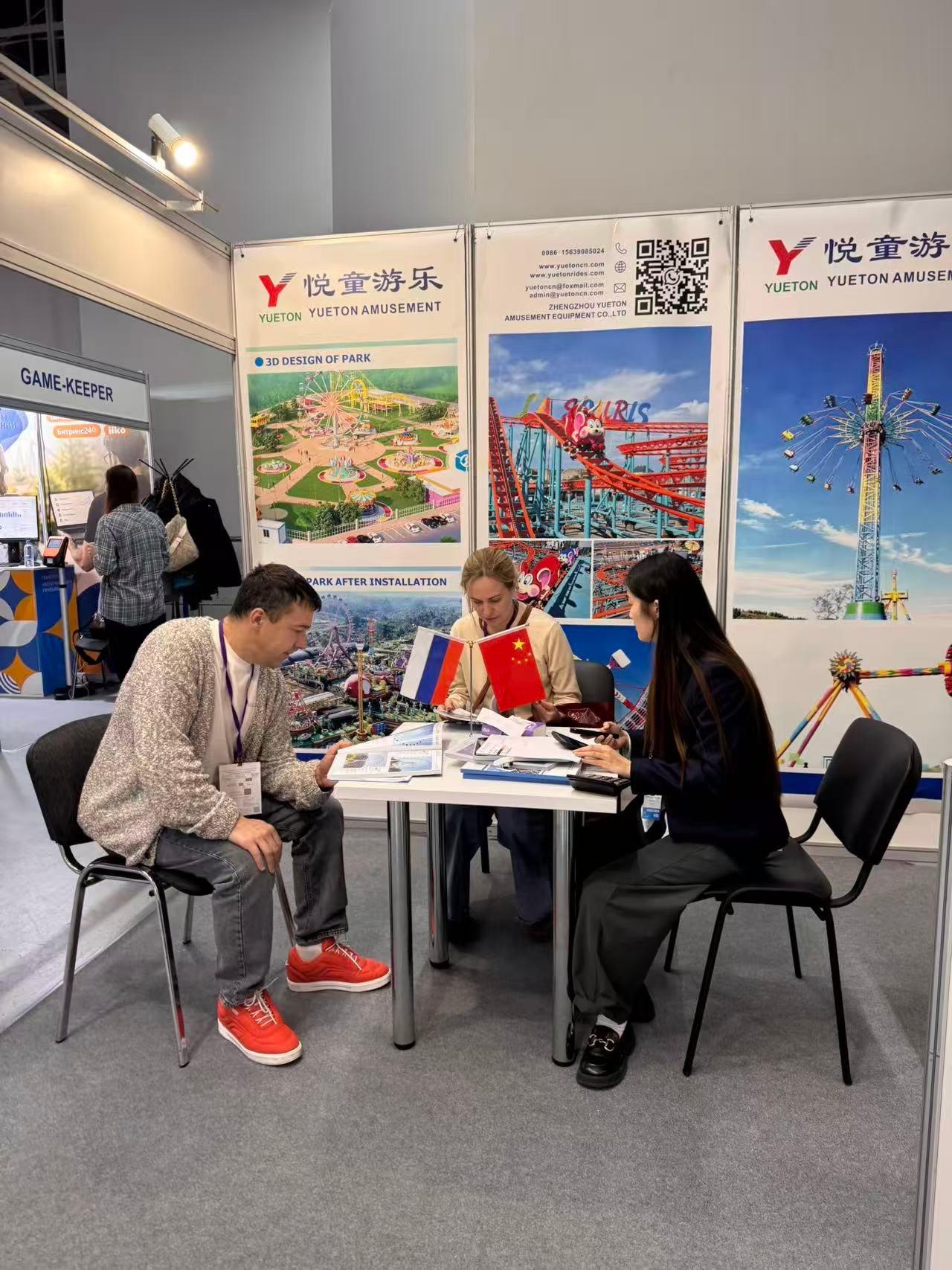 Russian visitors discussing park projects at the Yueton booth during RAAPA Autumn 2026 in Moscow