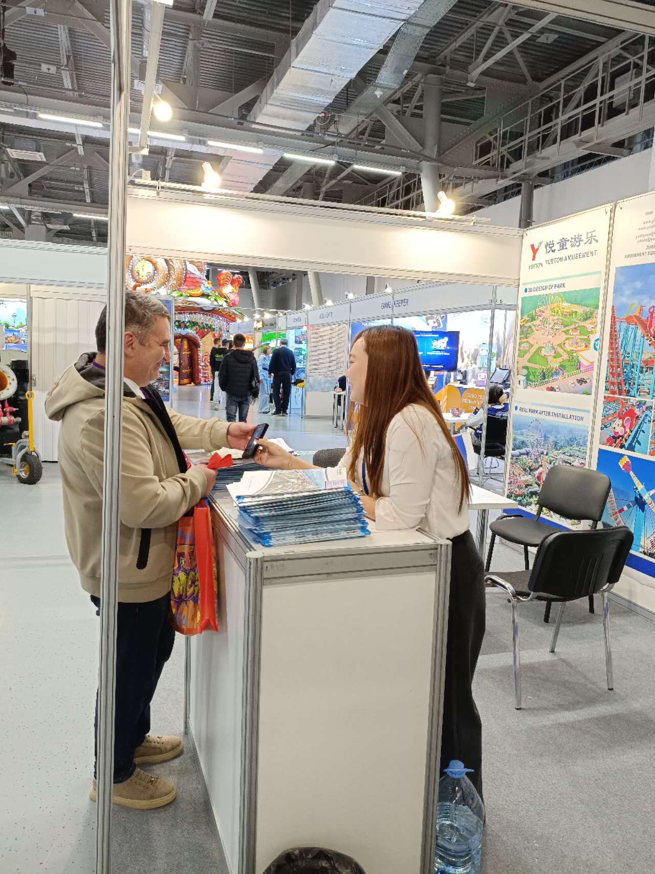 Russian visitor collecting product brochures at the Yueton stand, RAAPA Autumn 2026